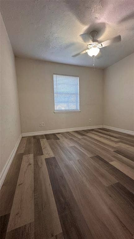 1217 Cloverdale Drive, Richardson, TX 75080 Room featuring wood-finish flooring, a neutral color palette, a window with horizontal blinds, and a ceiling-mounted light fixture with a fan