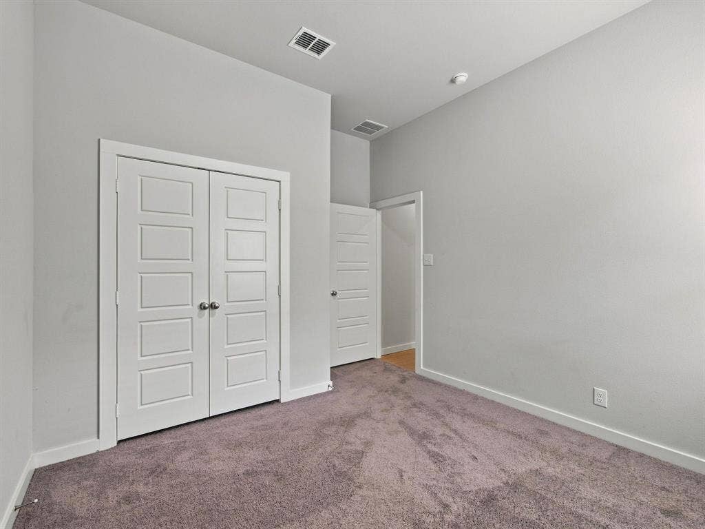 1157 Butterfly Dale Drive, Lavon, TX 75166 Room featuring neutral wall tones, high ceilings, carpeting, and white paneled doors