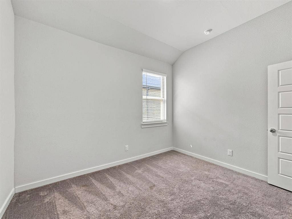 1157 Butterfly Dale Drive, Lavon, TX 75166 Vaulted ceilings, neutral wall color, single-pane window, and five-panel interior door with carpeted flooring