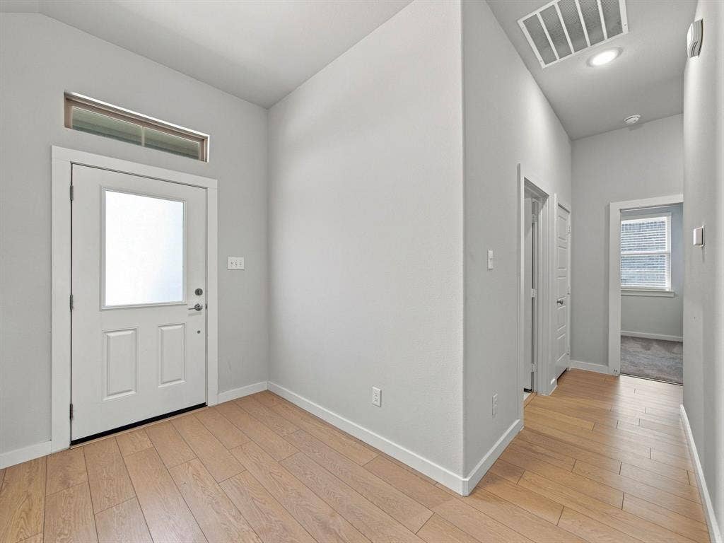 1157 Butterfly Dale Drive, Lavon, TX 75166 Entryway featuring wood-finish flooring, high ceilings, a door with a glass insert, and a transom window