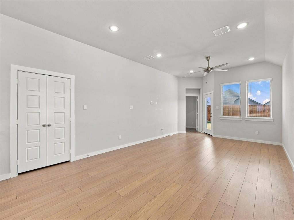 1157 Butterfly Dale Drive, Lavon, TX 75166 Vaulted ceilings with recessed lighting, wood-finish flooring, and double-door closet storage