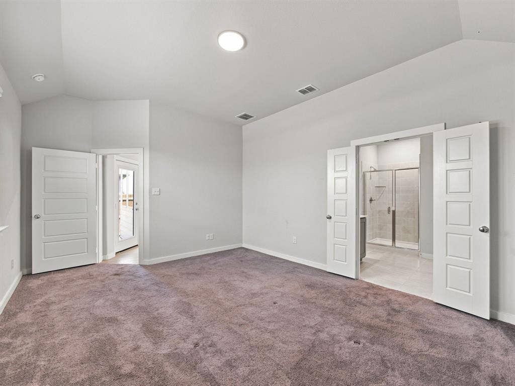 1157 Butterfly Dale Drive, Lavon, TX 75166 Vaulted ceiling, plush carpeting, five-panel interior doors, and a glass-enclosed shower stall