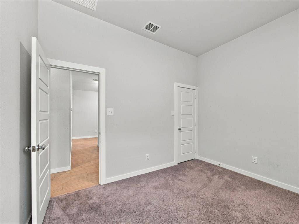 1157 Butterfly Dale Drive, Lavon, TX 75166 Neutral interior room featuring plush carpeting, high ceilings, and traditional-style four-panel doors