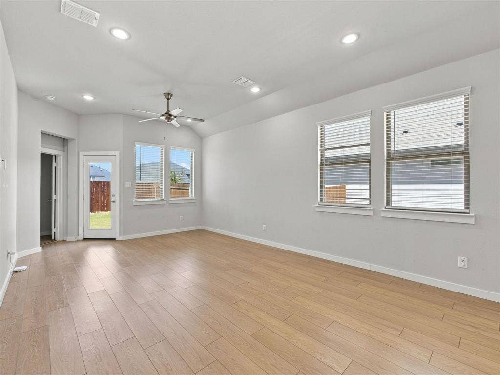1157 Butterfly Dale Drive, Lavon, TX 75166 Vaulted ceilings featuring recessed lighting, a central ceiling fan, wood-finish flooring, and multiple windows providing natural light