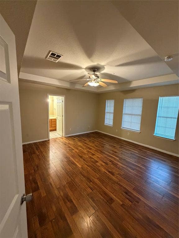 475 Perch Road, Rockwall, TX 75032 Room featuring wood-finish flooring, tray ceiling with a central multi-blade ceiling fan, and three windows