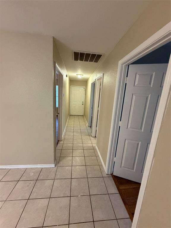 475 Perch Road, Rockwall, TX 75032 Hallway featuring neutral-toned tile flooring and multiple interior doors with multi-panel designs