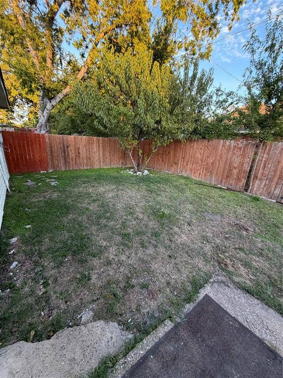475 Perch Road, Rockwall, TX 75032 Backyard featuring a grass lawn, perimeter wood fencing, and mature trees