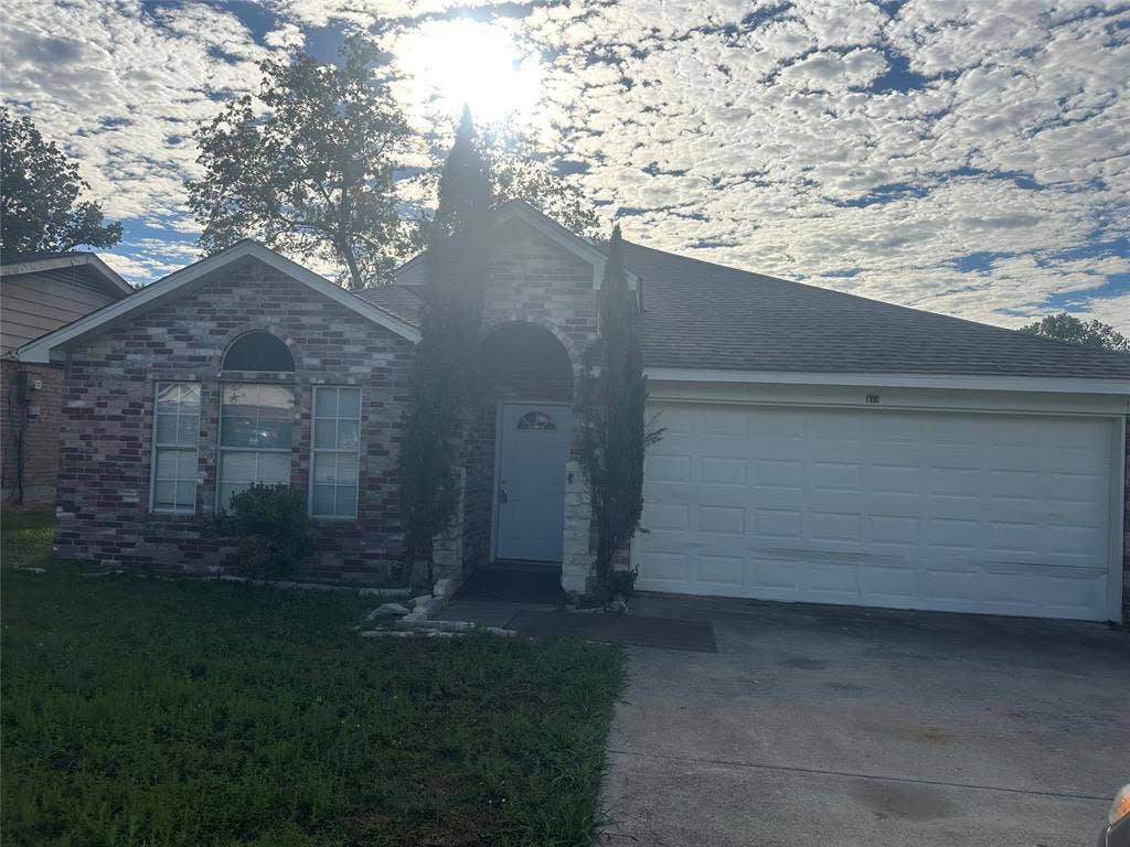 475 Perch Road, Rockwall, TX 75032 Brick exterior facade featuring a covered entryway, arched window detailing, and a two-car garage