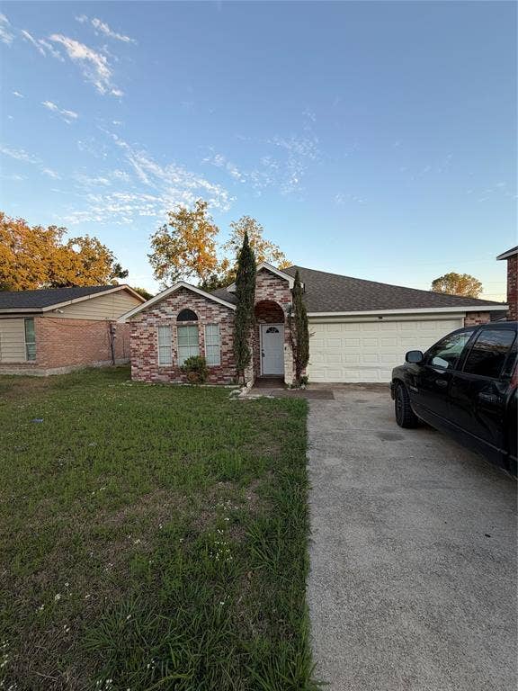 475 Perch Road, Rockwall, TX 75032 Single-story exterior featuring multi-toned masonry veneer, arched entryway, multi-pane window detail, and an attached two-car garage
