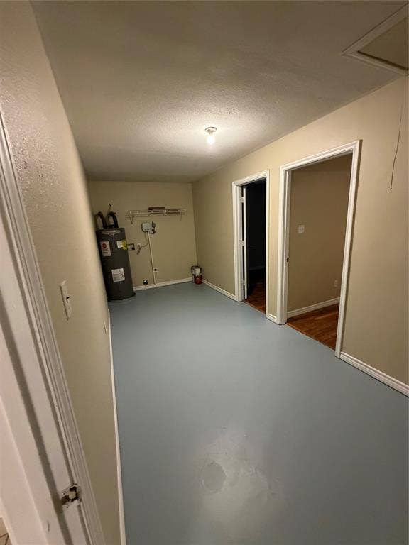 475 Perch Road, Rockwall, TX 75032 Utility area featuring a water heater, built-in wire shelving, and finished painted flooring