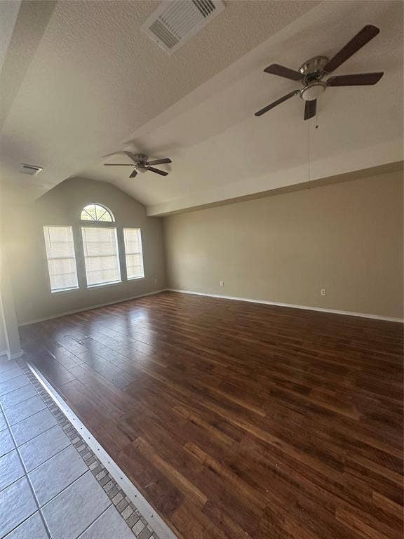 475 Perch Road, Rockwall, TX 75032 Vaulted ceilings, wood-finish flooring, two ceiling fans, and an arched transom window