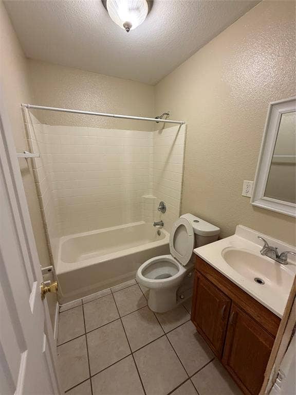 475 Perch Road, Rockwall, TX 75032 Bathroom featuring a tub-shower combination with tiled surround, a wooden vanity with an integrated sink, a wall-mounted mirror, and tile flooring