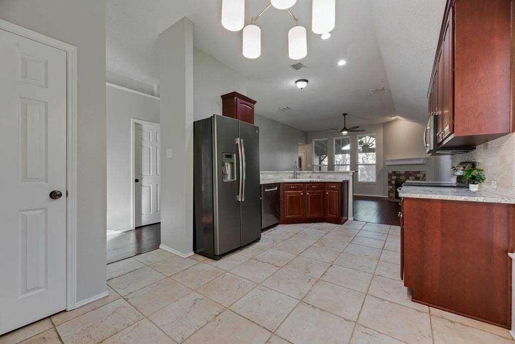 6310 Nueces Bay Drive, Rowlett, TX 75089 Chef's dream kitchen complete with new Bosch dishwasher, extended cabinets for extra storage space, granite counter tops, eat in kitchen with breakfast nook and bar, and sizeable pantry.