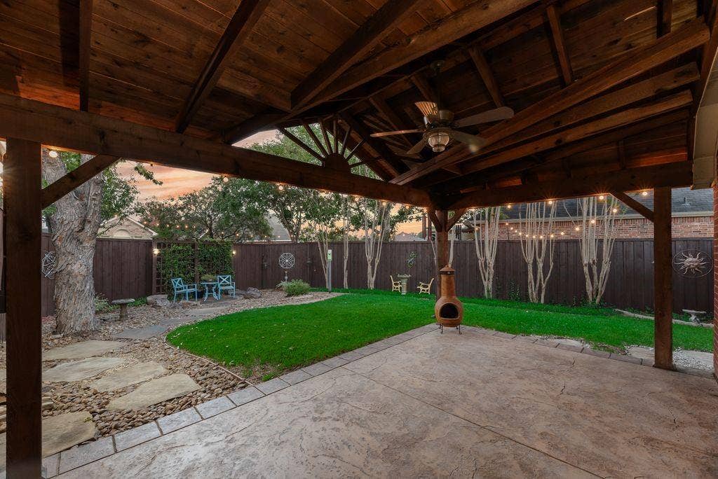 6310 Nueces Bay Drive, Rowlett, TX 75089 Amazing back yard and patio with stamped concrete, custom patio cover with TV connections and ceiling fan. Privacy fence, mature trees.