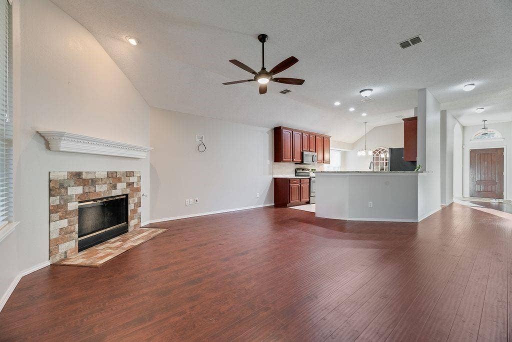 6310 Nueces Bay Drive, Rowlett, TX 75089 Family room with gas fireplace and gas logs. Naturally flows to kitchen and entry.