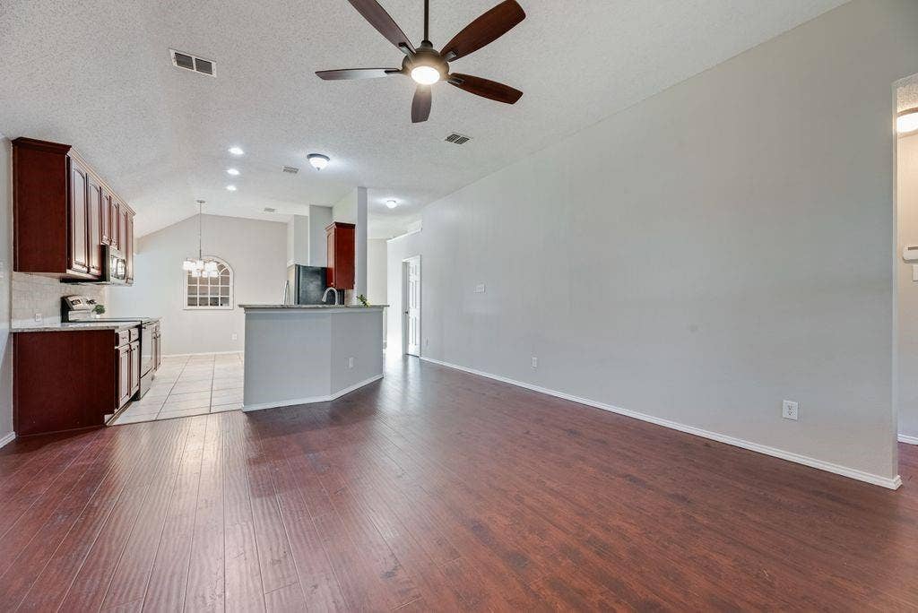 6310 Nueces Bay Drive, Rowlett, TX 75089 View from family room to kitchen. Primary bedroom suite to the right.