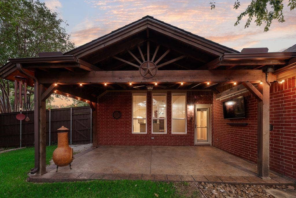 6310 Nueces Bay Drive, Rowlett, TX 75089 Beautiful back yard oasis. Covered patio, new windows and doors, stamped concrete, lush landscaping.