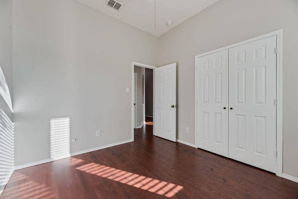 6310 Nueces Bay Drive, Rowlett, TX 75089 bedroom with ceiling fan and closet.