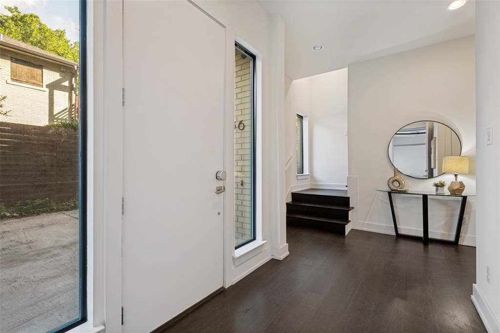 3336 Anchor Court, Dallas, TX 75219 Entryway featuring dark wood-finish flooring, recessed lighting, expansive vertical windows, and a tall solid-core entrance door