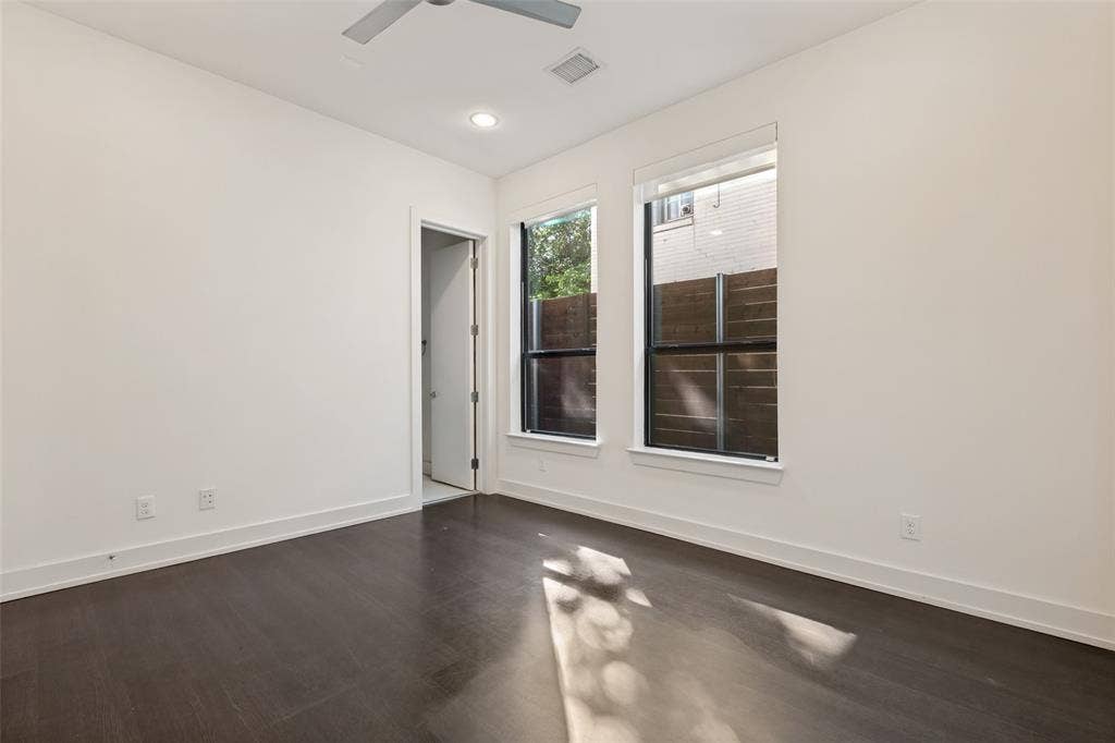 3336 Anchor Court, Dallas, TX 75219 Room featuring dark wood-finish flooring, high ceilings with recessed lighting, a ceiling fan, and dual windows with black frames