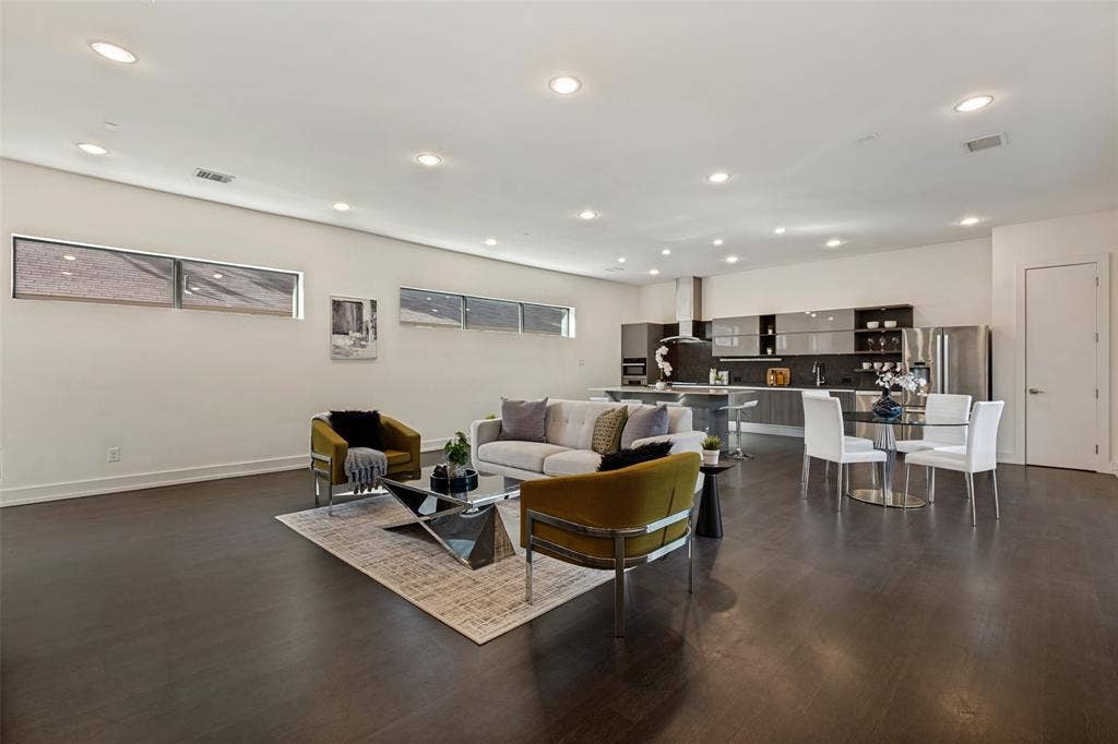 3336 Anchor Court, Dallas, TX 75219 Open-concept interior featuring wood-finish flooring, recessed lighting, clerestory windows, and modern cabinetry with integrated stainless steel appliances