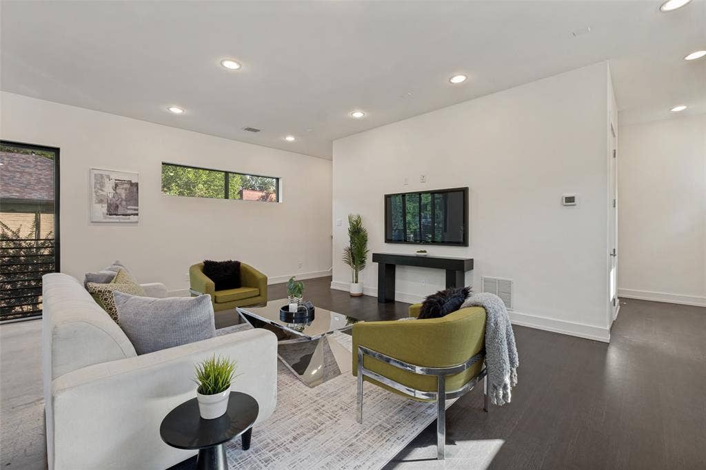 3336 Anchor Court, Dallas, TX 75219 Open-concept living space featuring wood-finish flooring, recessed lighting, and clerestory windows