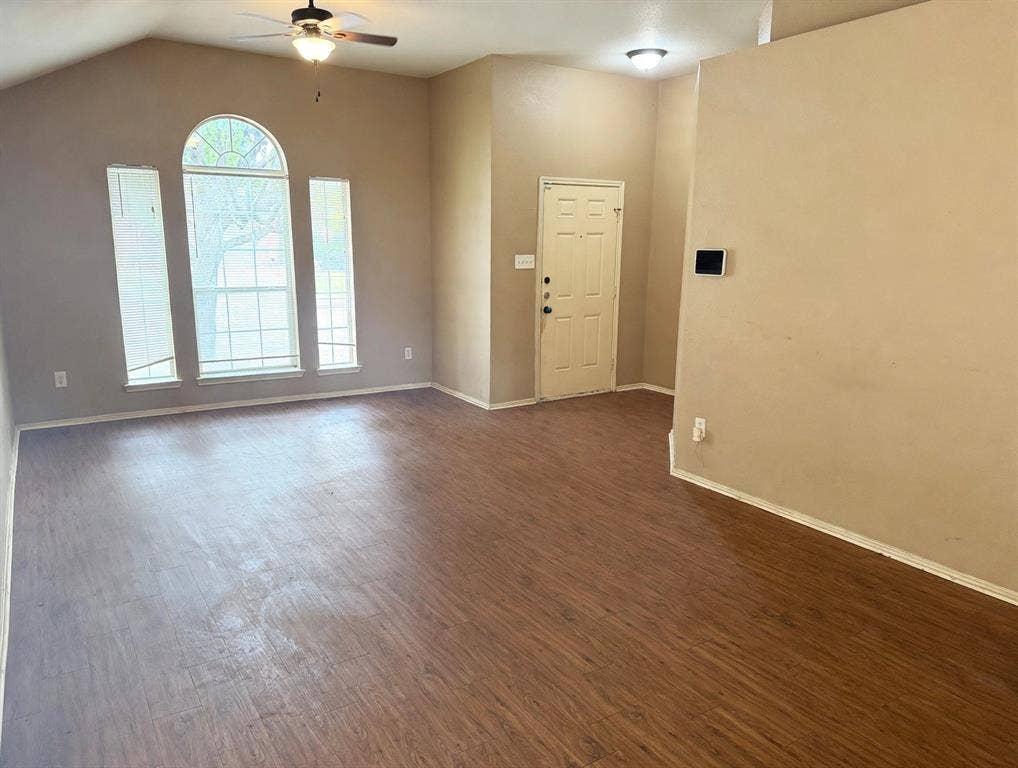 2053 Wild Creek Court, Dallas, TX 75253 Vaulted ceiling featuring an arched window configuration, wood-finish flooring, and a ceiling fan with light fixture