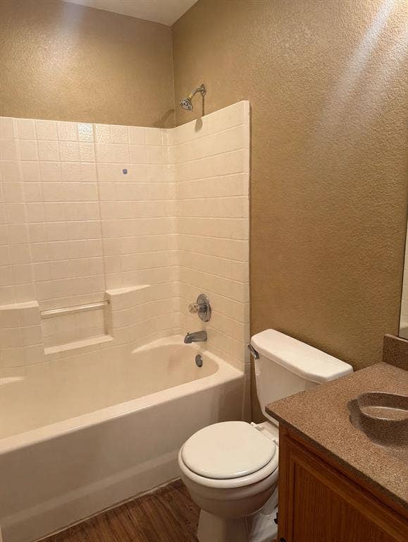 2053 Wild Creek Court, Dallas, TX 75253 Bathroom featuring a tub-shower combination with tiled surround, wood-finish flooring, vanity with integrated basin, and chrome hardware