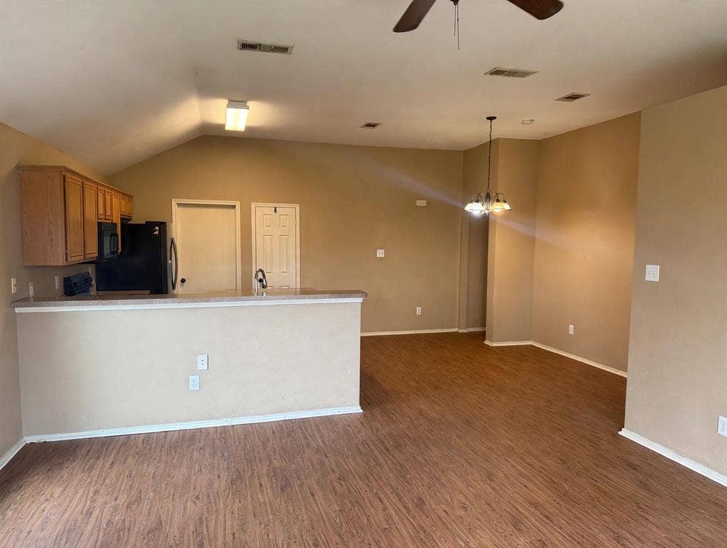 2053 Wild Creek Court, Dallas, TX 75253 Vaulted ceilings, wood-finish flooring, breakfast bar, and multi-light chandelier