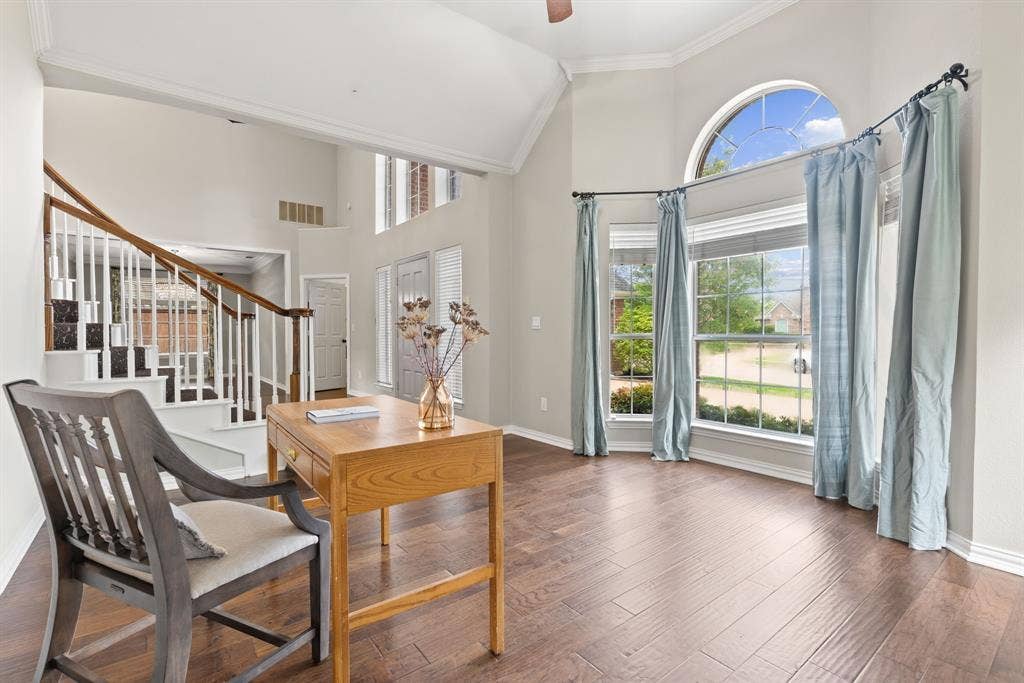 1110 Wedge Hill Road, McKinney, TX 75072 Vaulted ceilings, wood-finish flooring, staircase with wood handrail, and arched window bay