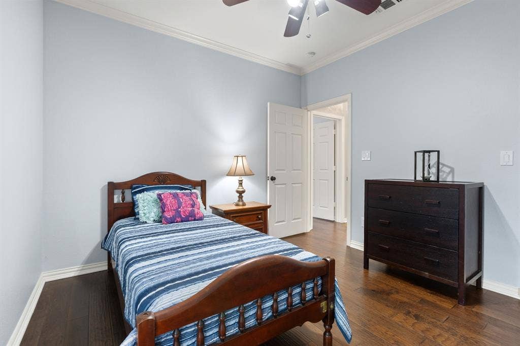 1110 Wedge Hill Road, McKinney, TX 75072 Wood-finish flooring, crown molding, and ceiling fan with integrated lighting