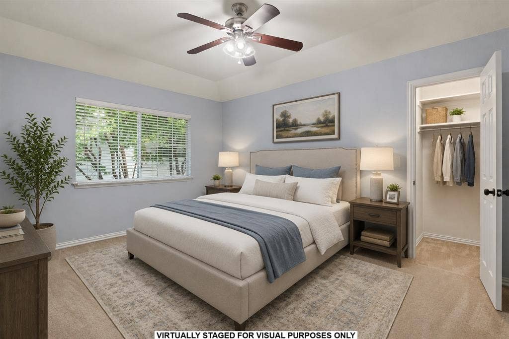 1110 Wedge Hill Road, McKinney, TX 75072 Bedroom featuring a tray ceiling, ceiling fan with integrated lighting, wall-to-wall carpeting, horizontal window blinds, and a built-in closet