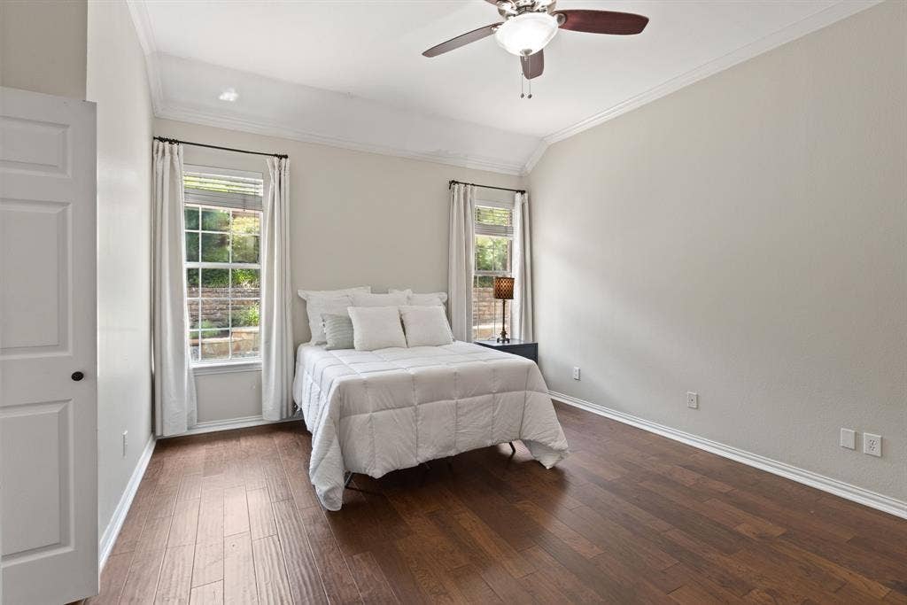 1110 Wedge Hill Road, McKinney, TX 75072 Vaulted ceilings, wood-finish flooring, and dual double-hung windows with neutral wall-mounted hardware and integrated ceiling fan