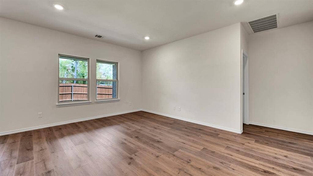 4033 Ripplewood Drive, Lindale, TX 75771 Wood-finish flooring, recessed lighting, and white walls with white trim