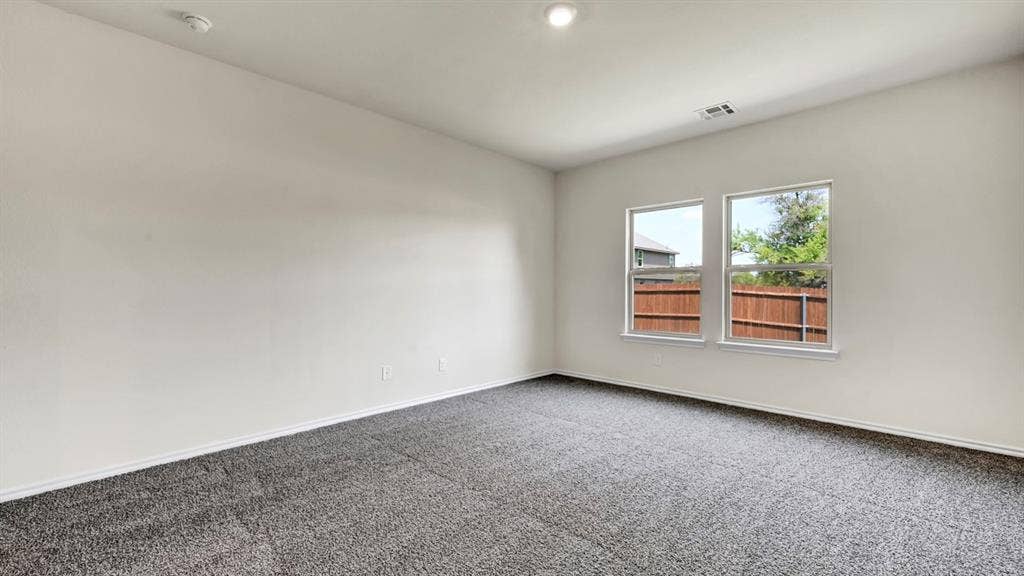 4033 Ripplewood Drive, Lindale, TX 75771 Recessed lighting, light gray carpet, and two double-hung windows