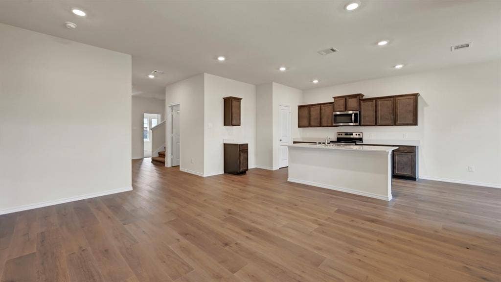 4033 Ripplewood Drive, Lindale, TX 75771 Open-concept space featuring wood-finish flooring and recessed lighting