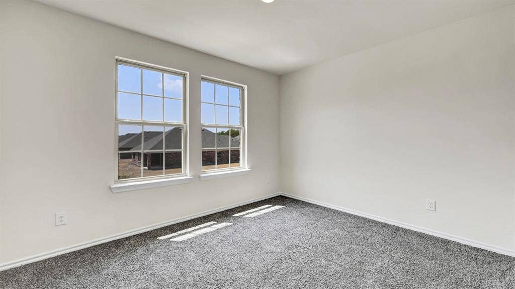 4033 Ripplewood Drive, Lindale, TX 75771 Neutral wall tones, recessed ceiling lighting, two double-hung windows, and grey carpeted flooring