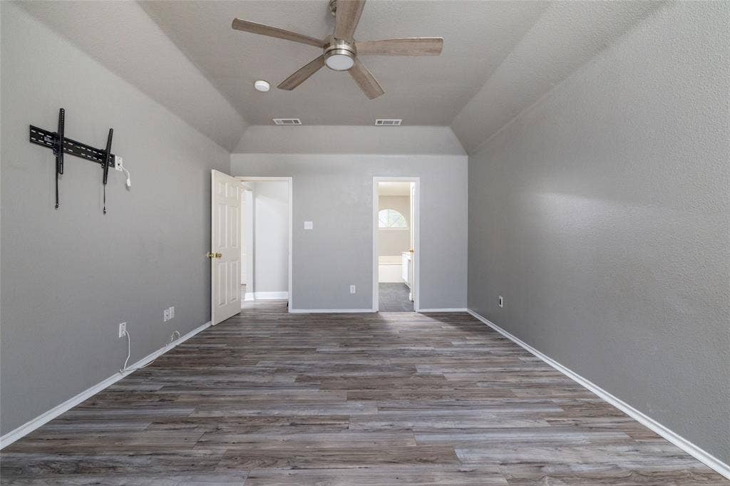 224 Cobblestone Circle, Red Oak, TX 75154 Tray ceiling, wood-finish flooring, and a multi-blade ceiling fan with integrated lighting