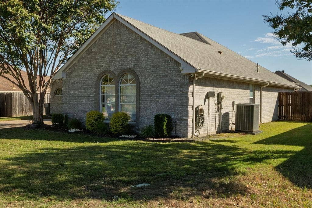 224 Cobblestone Circle, Red Oak, TX 75154 Brick exterior featuring a gabled roofline, arched windows with masonry detailing, and professional landscaping