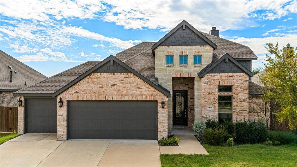 408 Abbott Lane, Waxahachie, TX 75165 Multi-gabled exterior featuring light brick masonry, decorative shingle siding, a multi-car garage, and a recessed entryway with a glass-paneled door