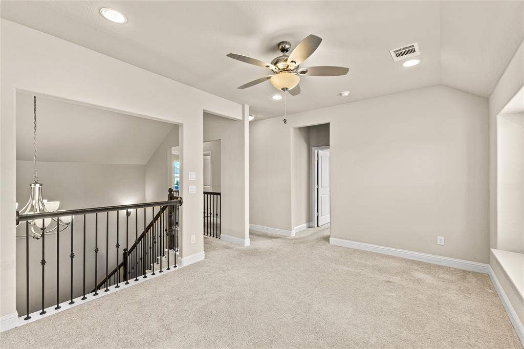 408 Abbott Lane, Waxahachie, TX 75165 Vaulted ceiling, ceiling fan with light fixture, carpeted flooring, built-in window seat, and metal spindle railing