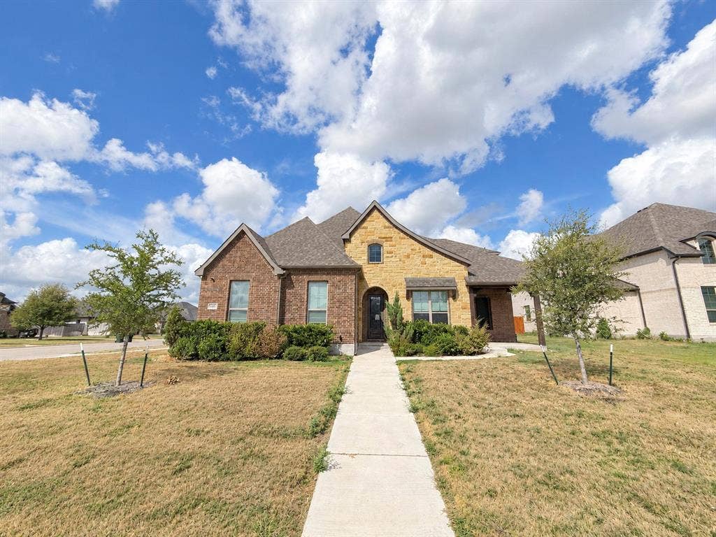 6414 Waggoner Court, Temple, TX 76502 Multi-gable exterior featuring a combination of brick and natural stone masonry, concrete walkway, and shingled roof