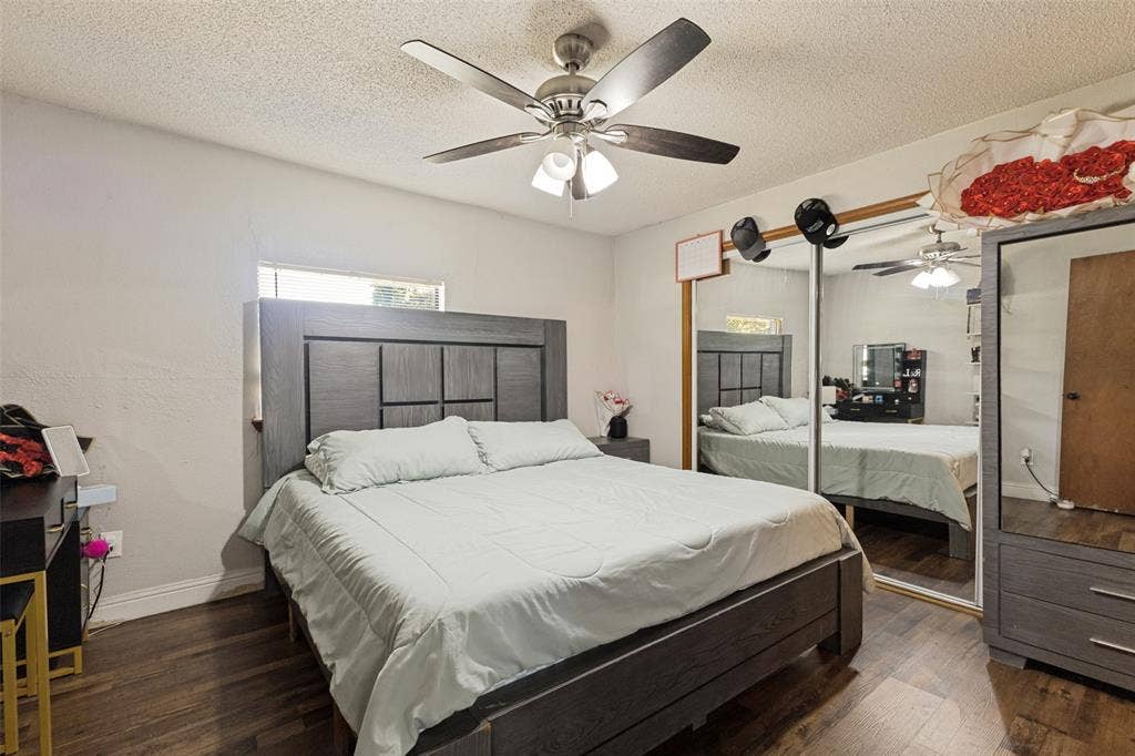 7400 County Road 131A, Terrell, TX 75161 Wood-finish flooring, ceiling fan with integrated lighting, and dual sliding mirrored closet doors