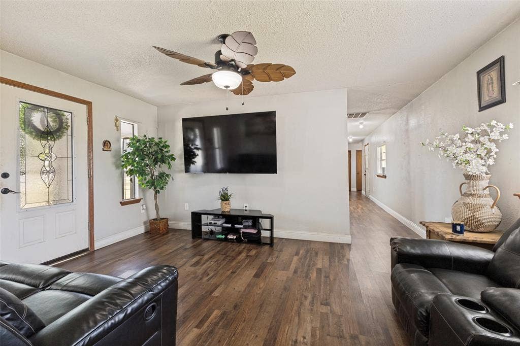 7400 County Road 131A, Terrell, TX 75161 Wood-finish flooring, ceiling fan with light fixture, and door featuring decorative glass inlay