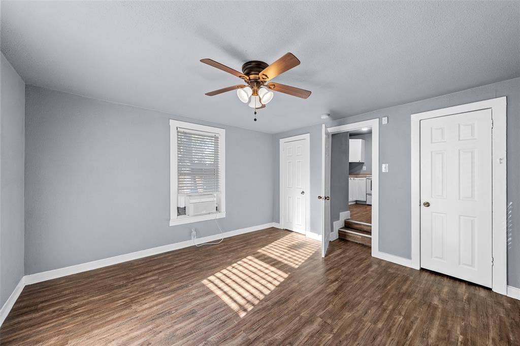 2222 Speight Avenue, Waco, TX 76706 Wood-finish flooring, multi-panel doors, neutral wall paint, and a ceiling fan with integrated lighting