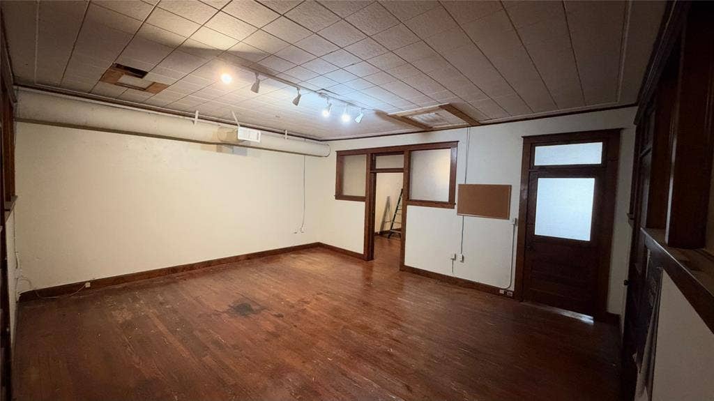 111 E Virginia Street, McKinney, TX 75069 ~358 SF office or conference room with original hardwood floors and wood trim