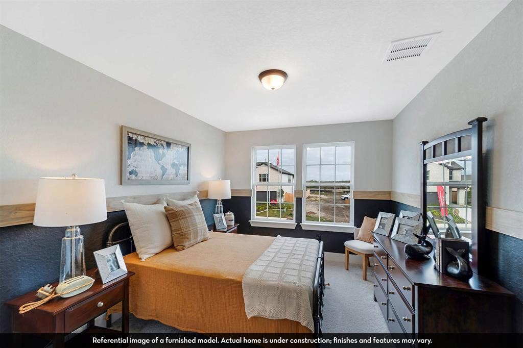 3009 Merrick Drive, Crandall, TX 75114 Dual-tone interior walls featuring wood trim detailing, neutral carpeting, and two double-pane windows