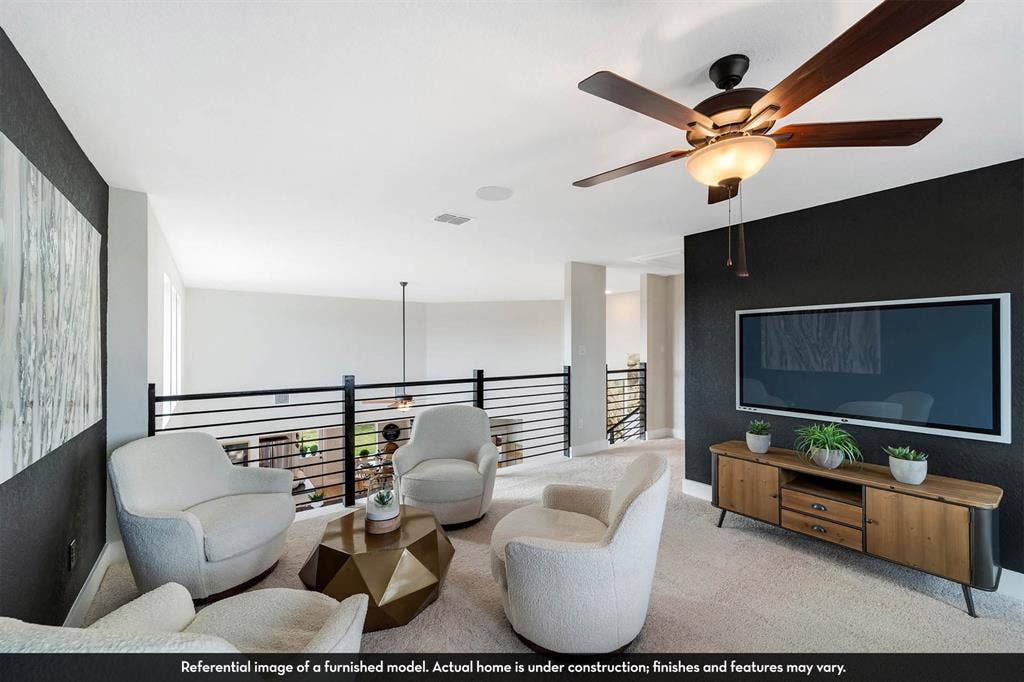 3009 Merrick Drive, Crandall, TX 75114 Open-concept area featuring a metal horizontal-bar railing, a dark accent wall, and a ceiling fan with integrated lighting