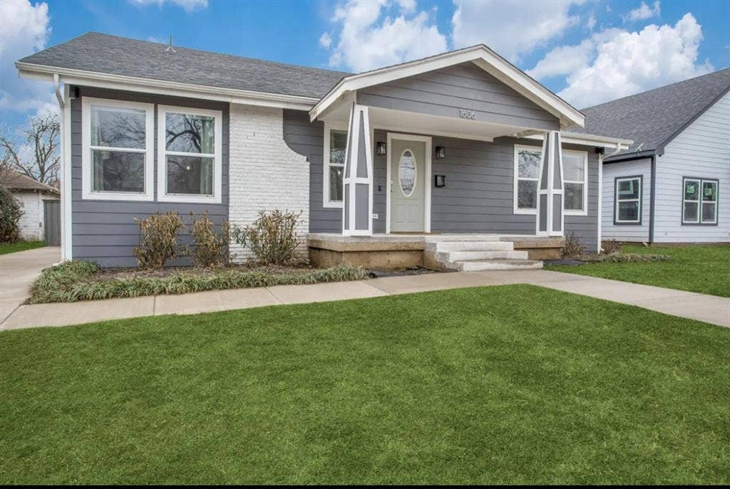1606 W 12th Street, Dallas, TX 75208 Exterior facade featuring gray lap siding, white brick accents, a covered front porch with tapered columns, and a concrete walkway
