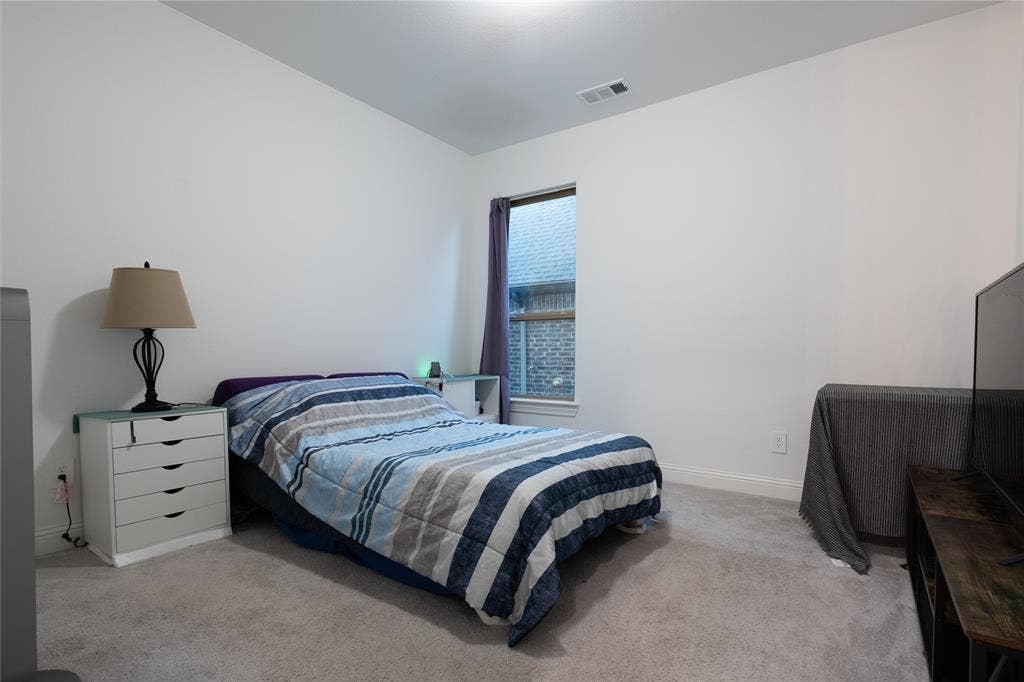 415 Rock Rose Lane, Wylie, TX 75098 Neutral wall tones, wall-to-wall carpeting, and a single vertical window